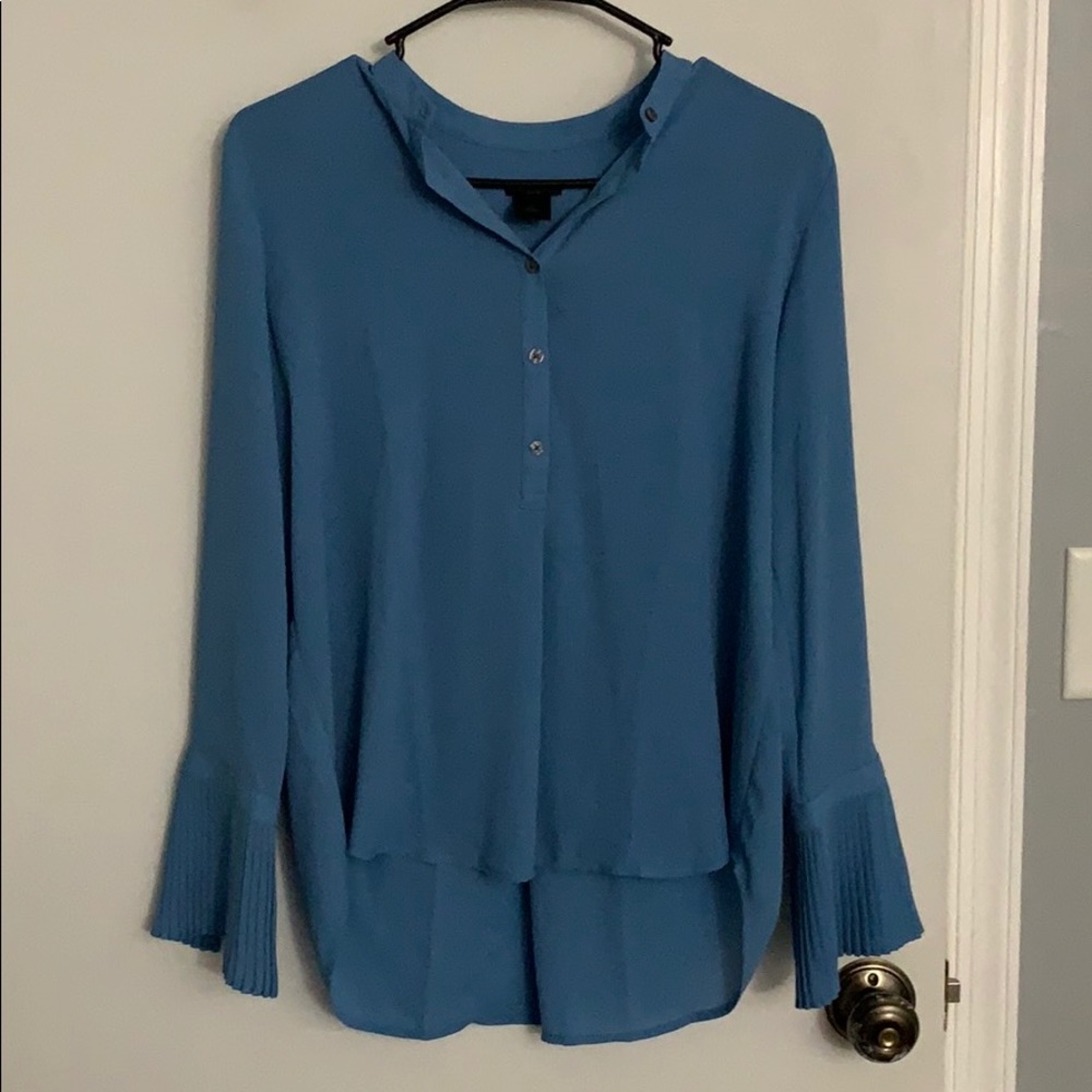 Women’s long sleeve blouse with frilled sleeves.